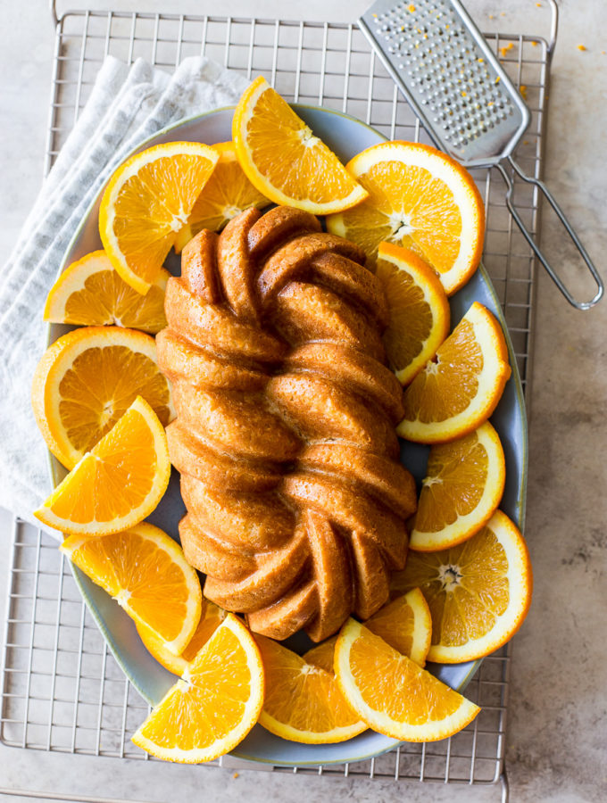Overhead photo of an orange loaf cake surrounded by orange slices