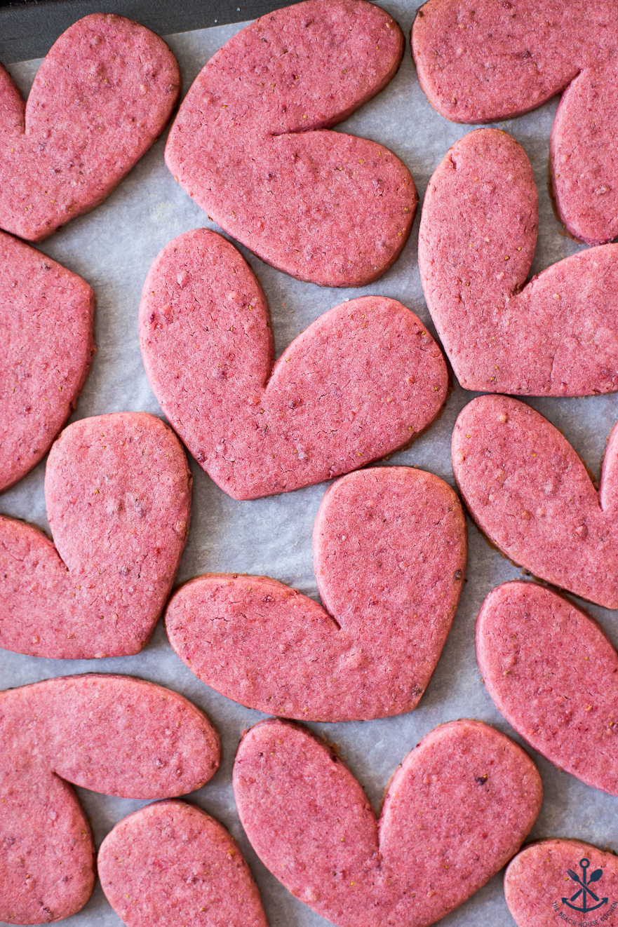 Up close overhead photo of a tray of pink heart sugar cookies