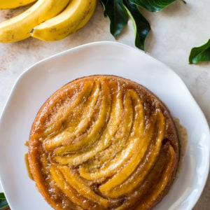 Overhead photo of banana upside-down cake on a white platter