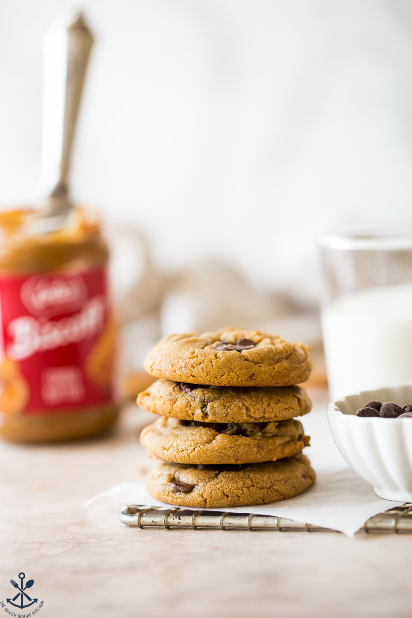 A stack of cookies with a jar of cookie butter in the background