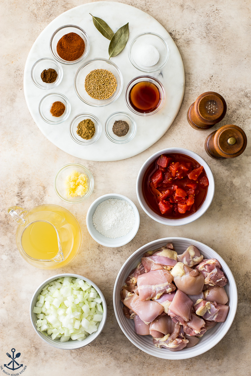 Overhead photo of ingredients for chicken vindaloo in bowls
