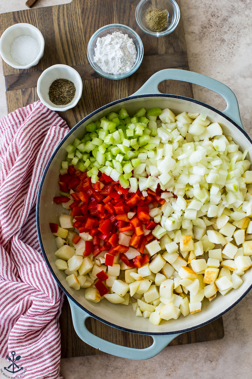 Overhead photo of a skillet of potatoes, red peppers, onions and celery