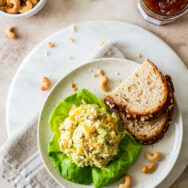 Overhead photo of a plate of curried chicken salad and slice of bread