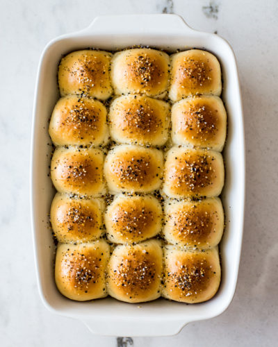 Overhead photo of a baking dish of soft everything dinner rolls