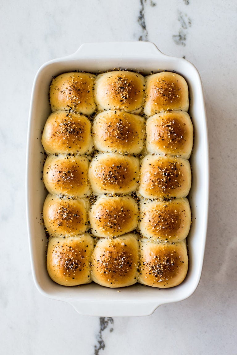 Overhead photo of a baking dish of soft everything dinner rolls