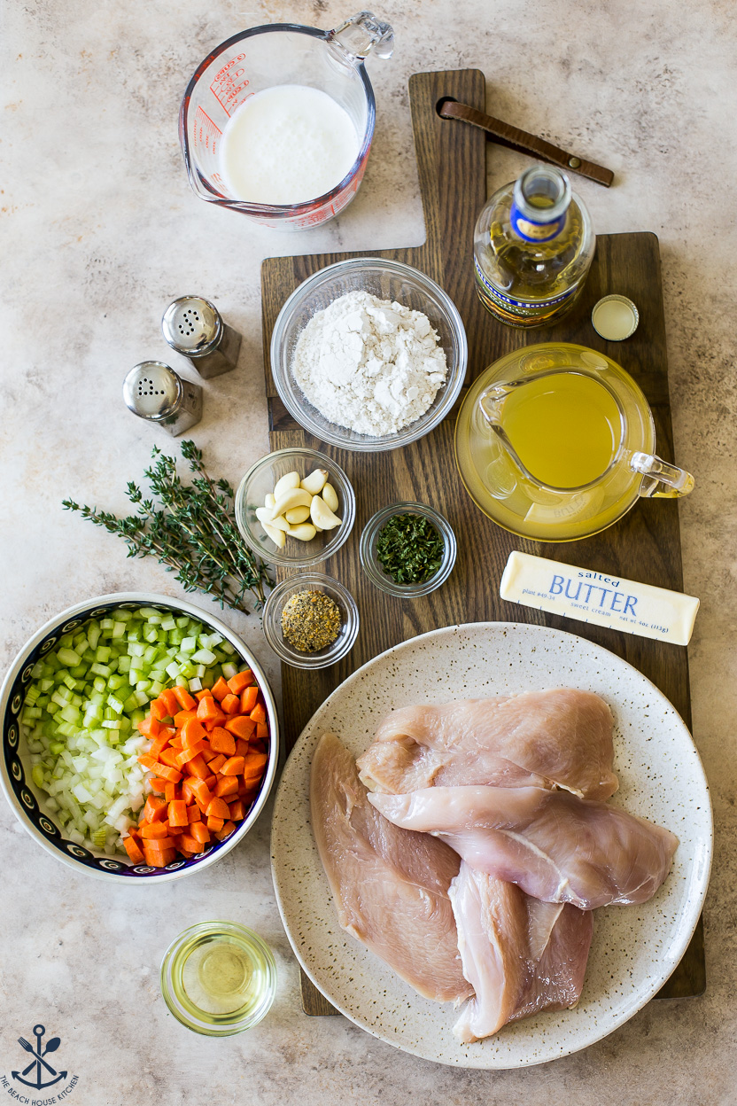 Overhead photo of ingredients for chicken dish on a wooden board