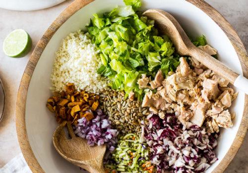 Overhead photo of a bowl filled with Thai chili mango tuna chopped salad ingredients