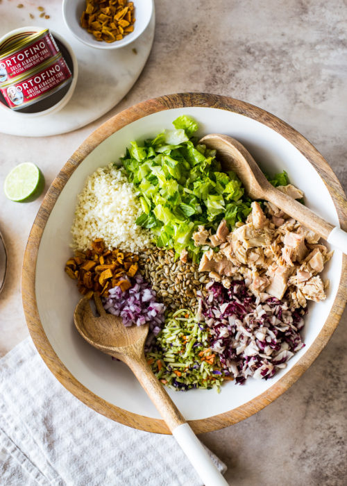 Overhead photo of a bowl filled with Thai chili mango tuna chopped salad ingredients
