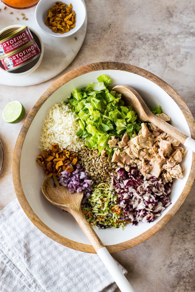 Overhead photo of a bowl filled with Thai chili mango tuna chopped salad ingredients