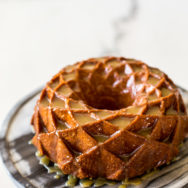 A bundt cake on a marble round cake stand