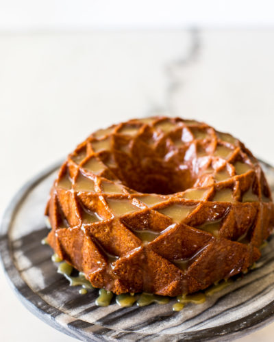 A bundt cake on a marble round cake stand