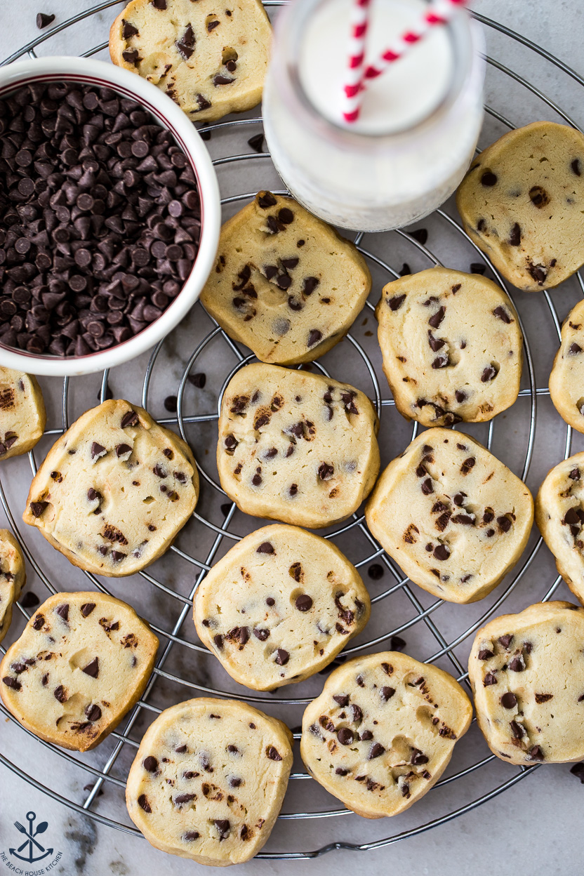 Up close overhead photo of some coconut chocolate chip cookies on a round wire rack