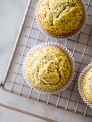Overhead photo of Meyer lemon poppy seed muffins on a gold wire rack