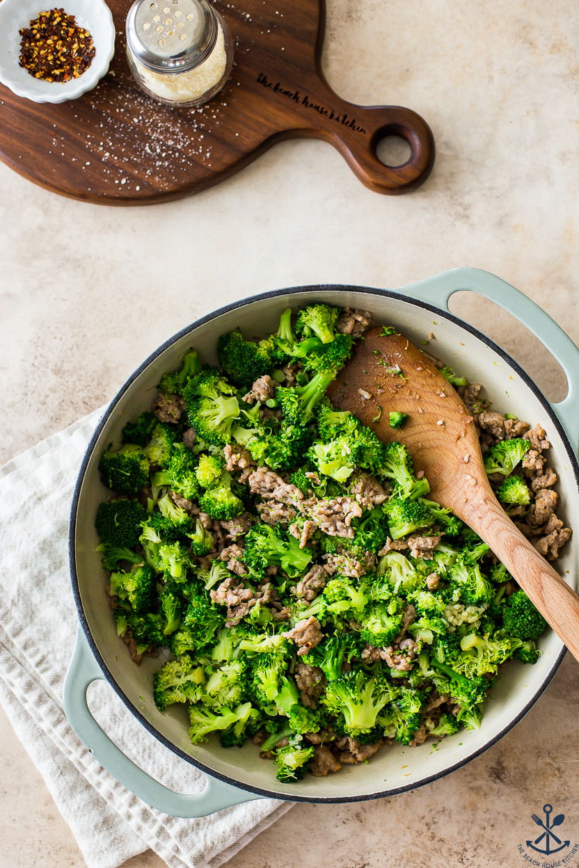 Overhead photo of a skillet of chopped broccoli and Italian sausage