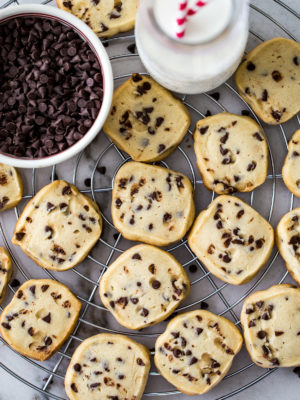 Up close overhead photo of chocolate chip cookies on a round wire rack