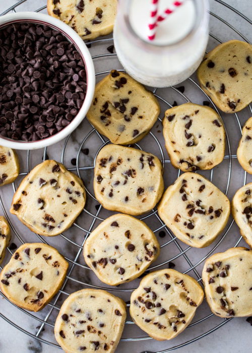Up close overhead photo of chocolate chip cookies on a round wire rack