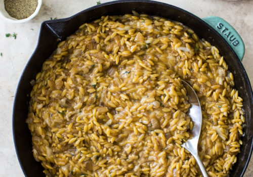 Overhead photo of a skillet of French Onion Orzo