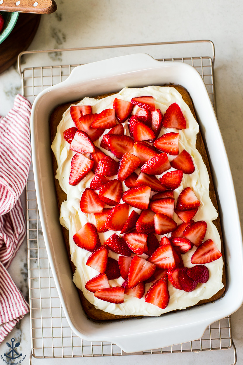 Overhead photo of a 9x13 pan cake topped with strawberries