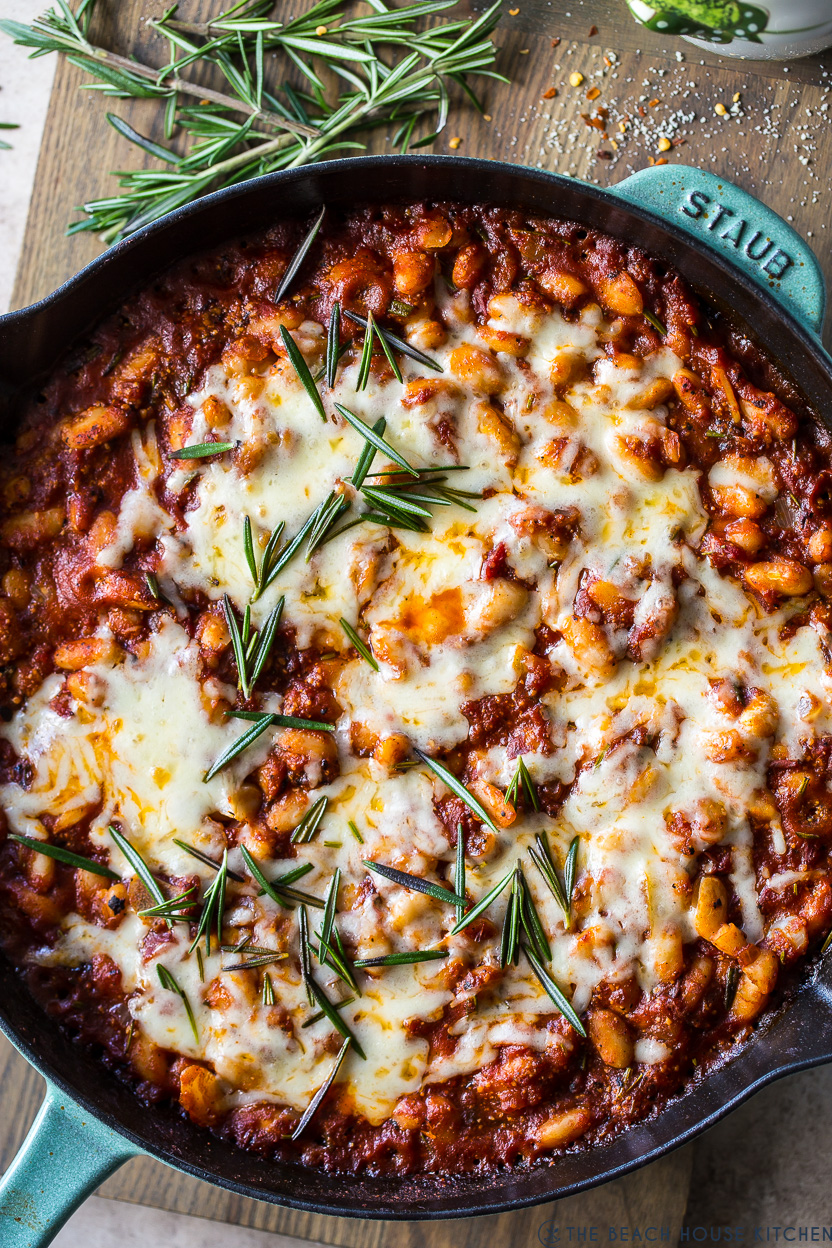 Up close overhead photo of a skillet of Cheesy Italian Baked Beans
