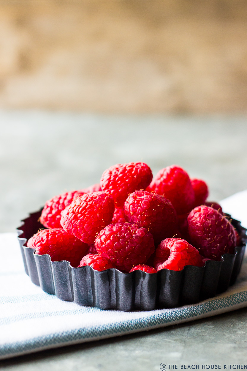 Up close photo of a small tart pan of fresh raspberries