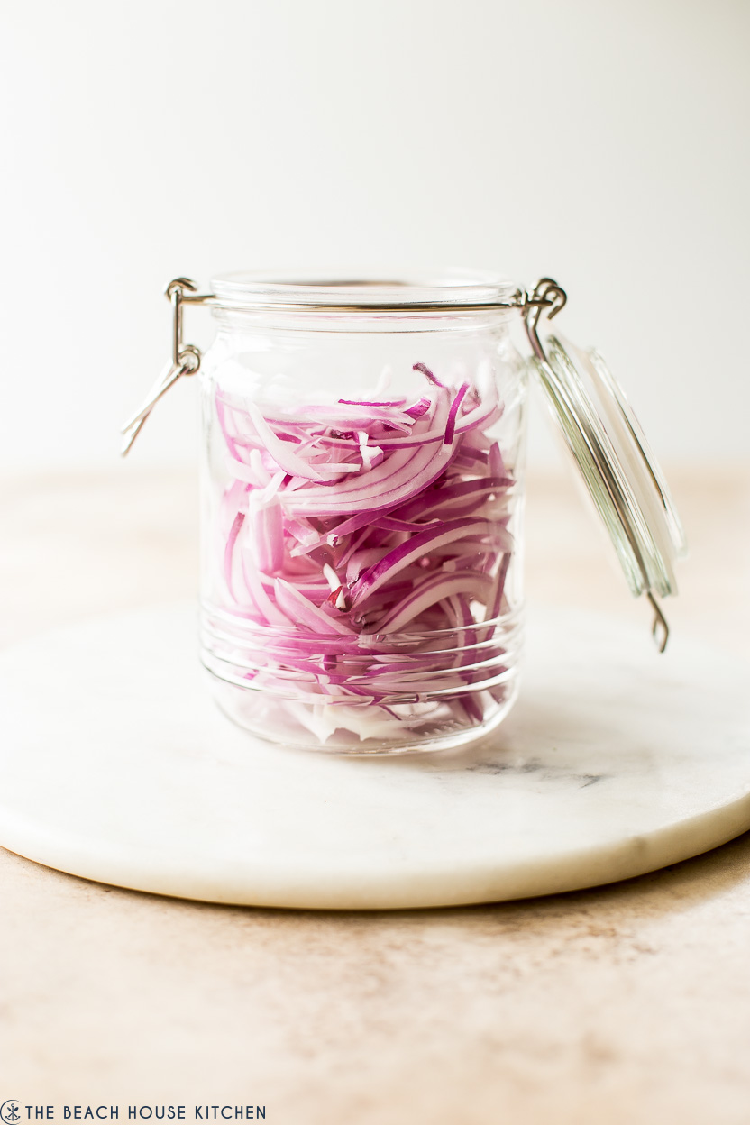 A jar filled with red onion slices