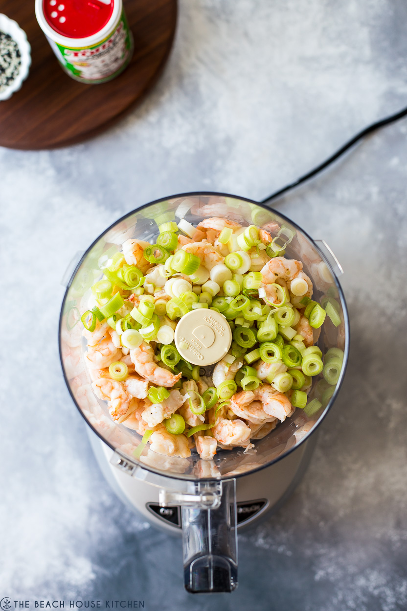 Overhead photo of a food processor of shrimp and green onions