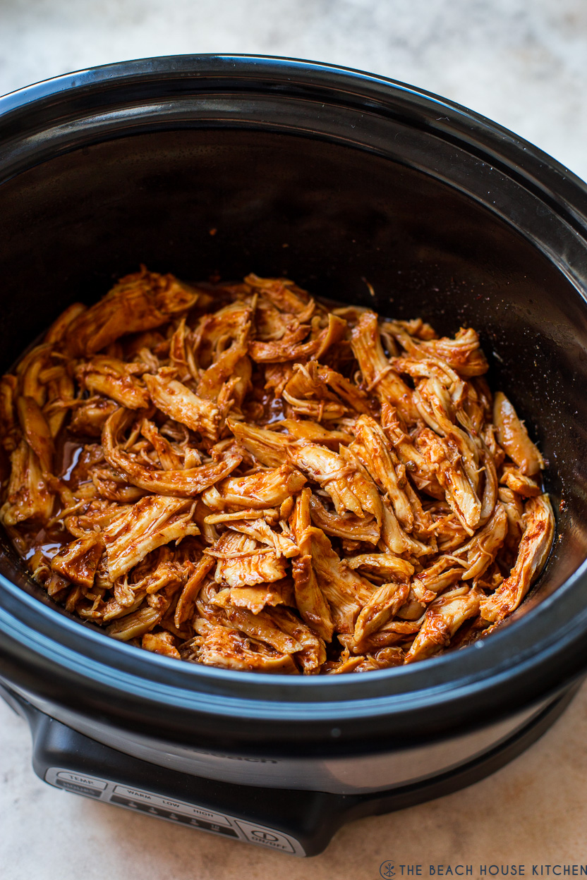 Overhead photo of a slow cooker of shredded honey chipotle chicken