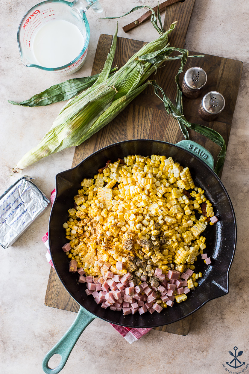 Overhead photo of a skillet filled with corn, spices and ham