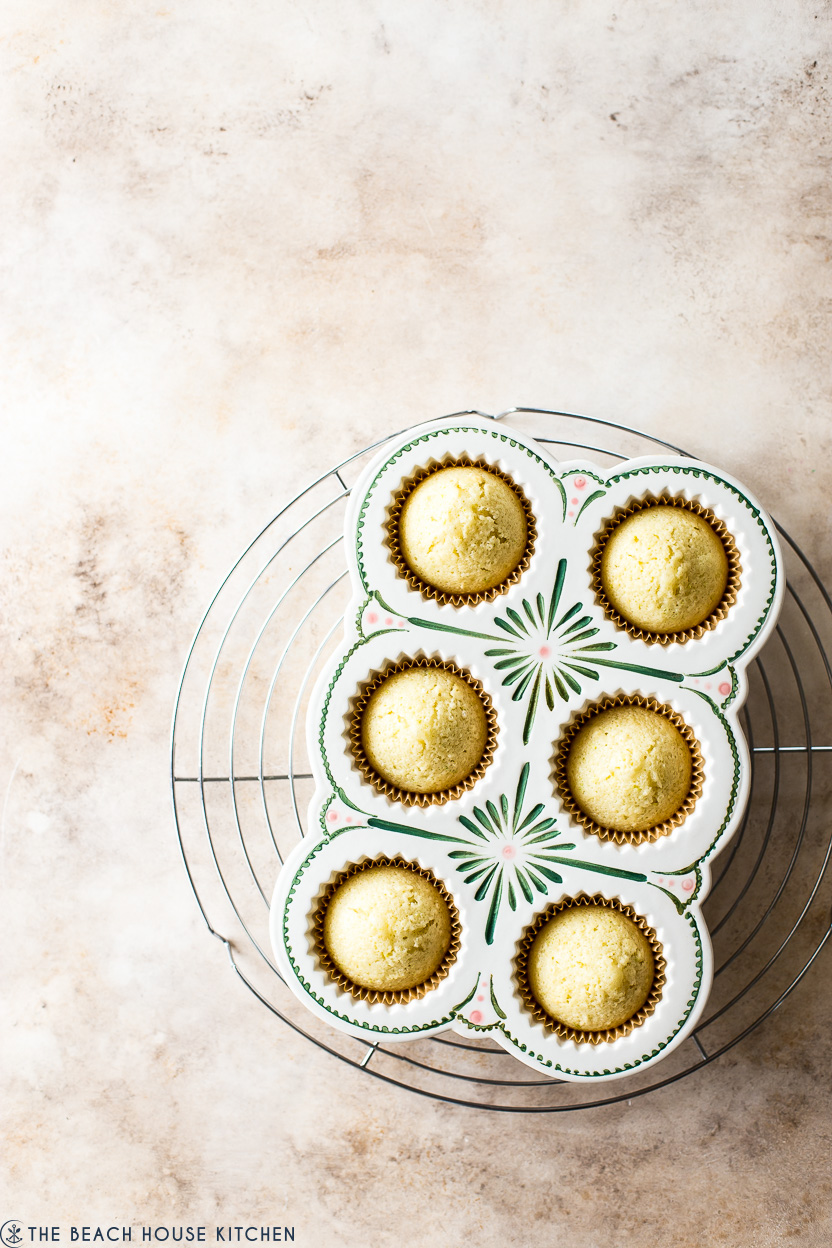 Overhead photo of cupcake pan of baked yellow cupcakes