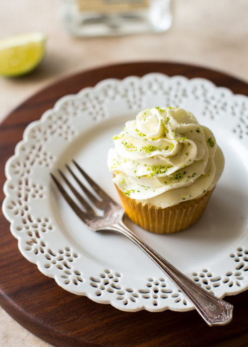 A margarita cupcake on a white plate with a fork