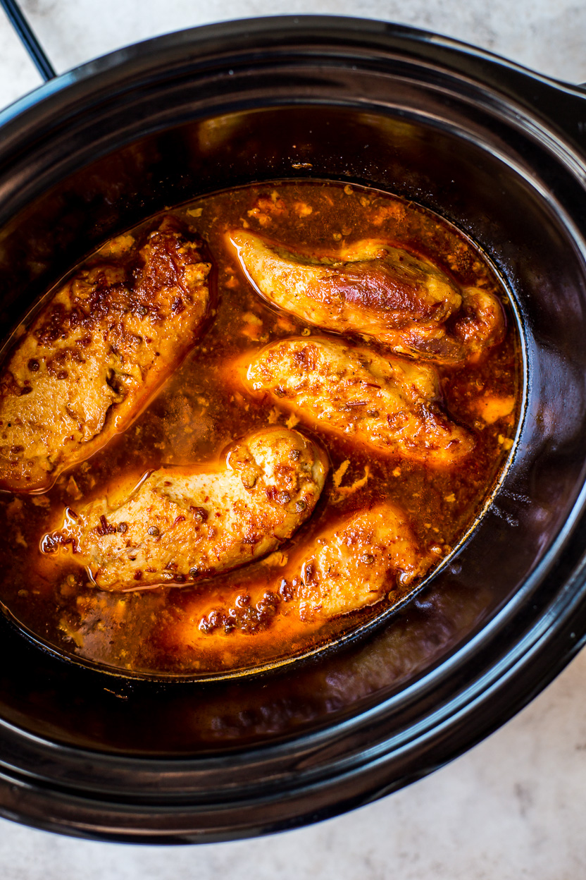 Overhead photo of cooked chicken in a slow cooker