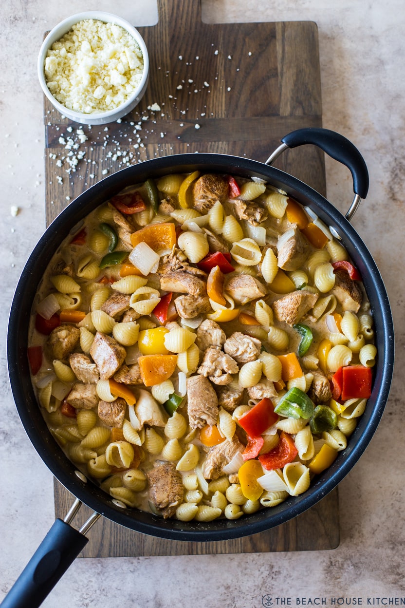 Overhead photo of pasta, chicken and veggies in a skillet