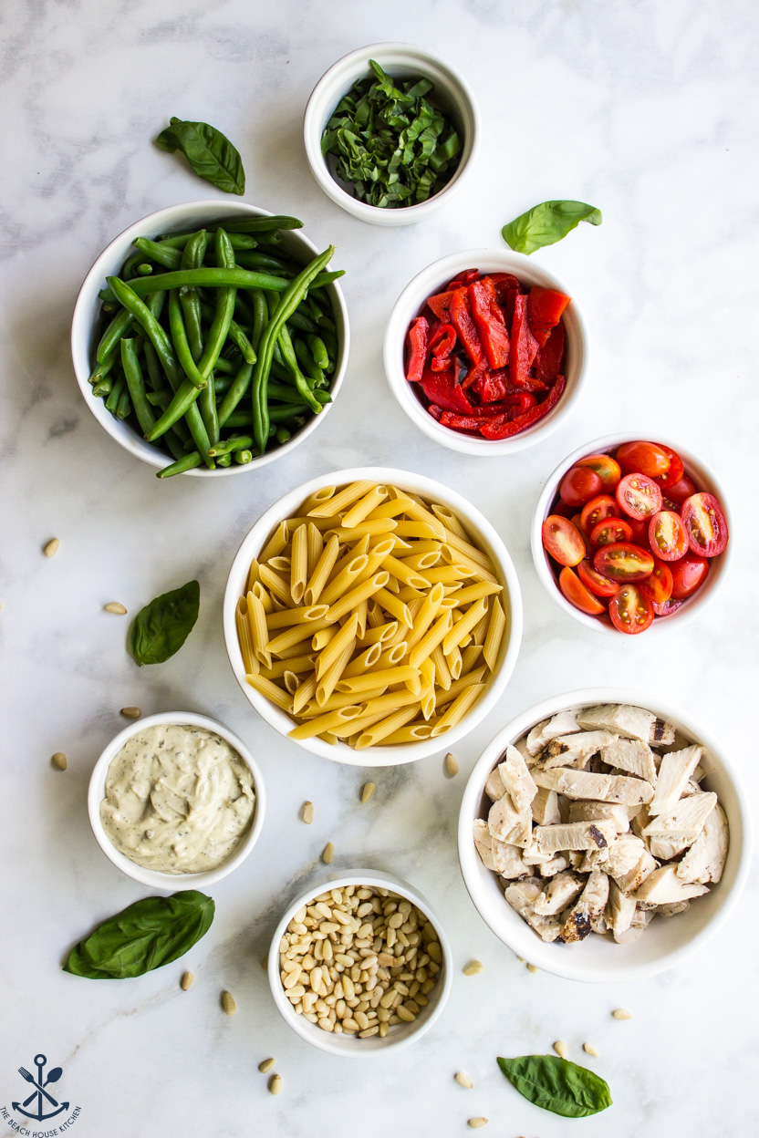 Overhead photo of ingredients for a pasta salad in bowls