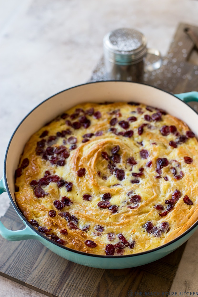 A cranberry orange dessert in a turquoise baking dish