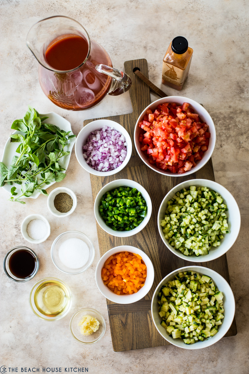 Overhead photo of ingredients for gazpacho in individual bowls