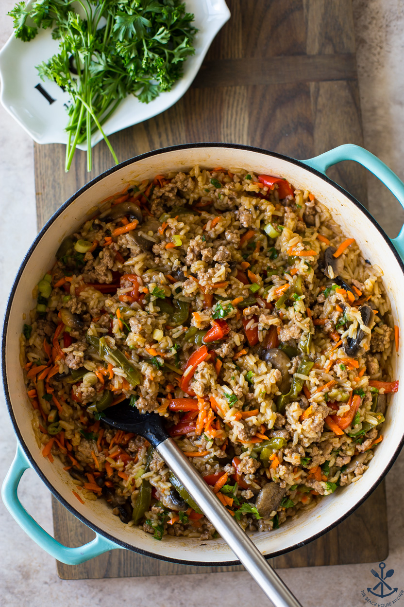 Overhead photo of a baking dish of rice, vegetables and ground pork