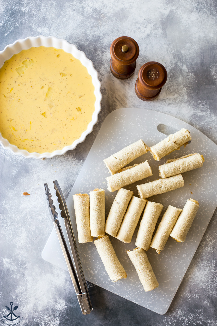 Overhead photo of French toast roll-ups and a plate of egg mixture and salt and pepper