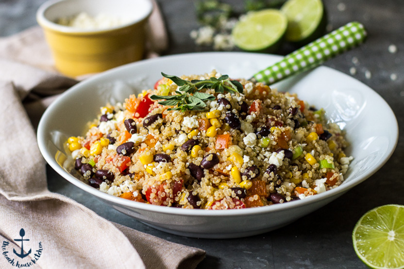A Southwestern Quinoa Salad with Lime Dressing and Cotija Cheese in a white bowl