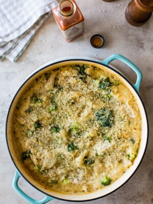 Overhead photo of a cheesy chicken broccoli rice bake in a skillet