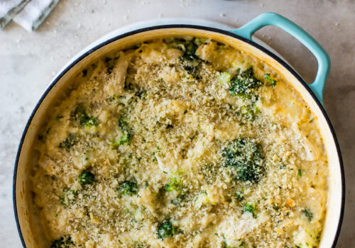 Overhead photo of a cheesy chicken broccoli rice bake in a skillet