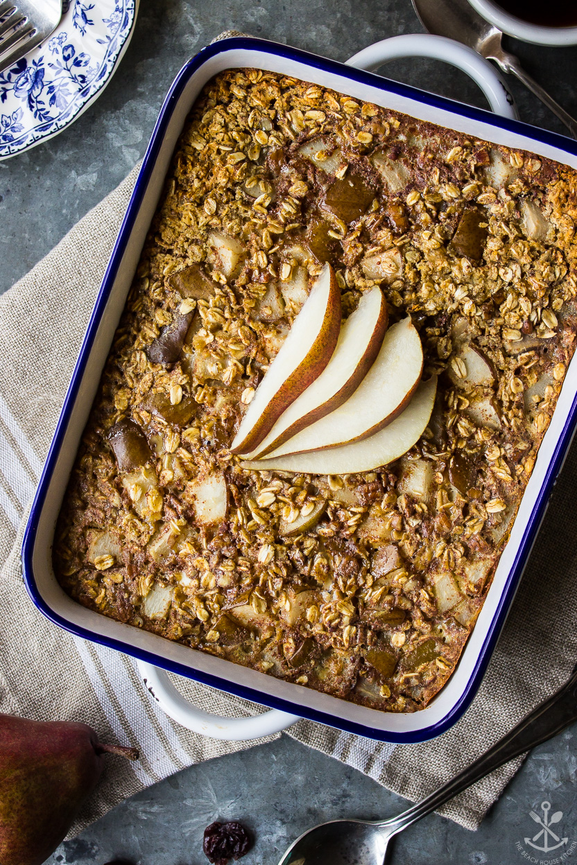 Overhead photo of a baking dish of Cherry Pear Baked Oatmeal topped with pear slices