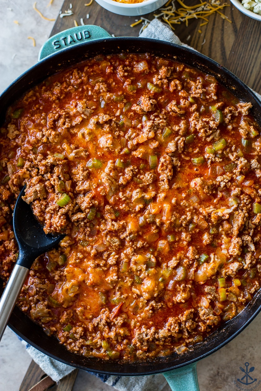 Up close overhead photo of a skillet of ground turkey meat with buffalo sauce
