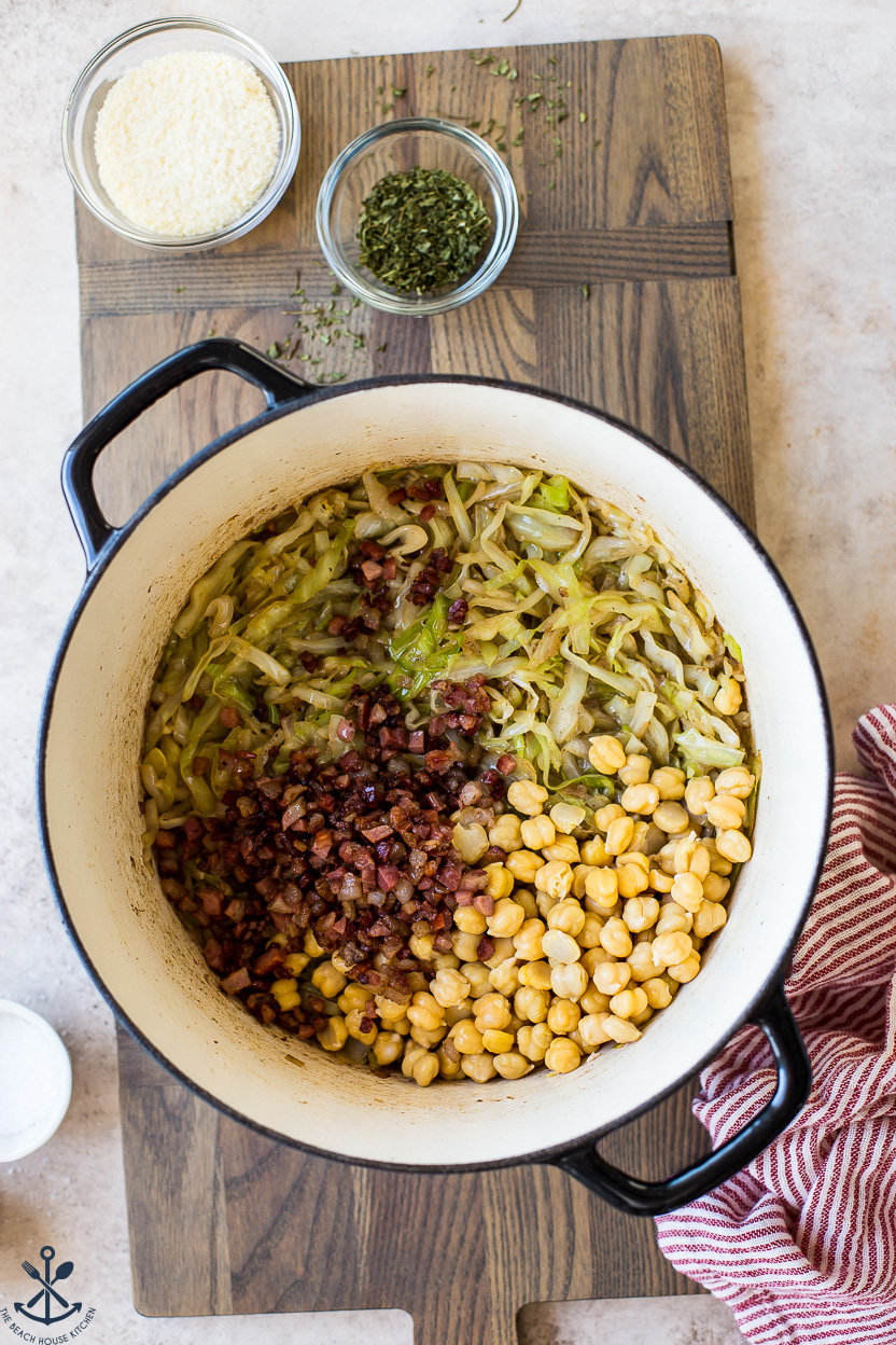 Overhead photo of a pot of cooked cabbage, pancetta and chickpeas