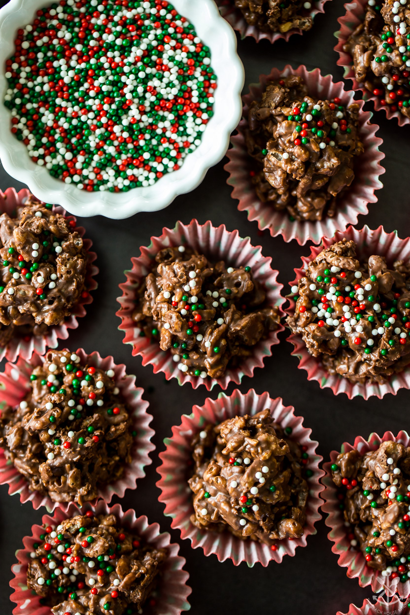 Overhead up close photo of chocolate crunch cups with a small bowl of holiday nonpariels