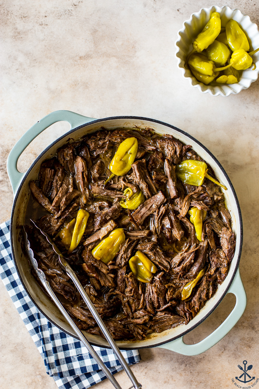 Overhead photo of a baking dish of pot roast with yellow peppers