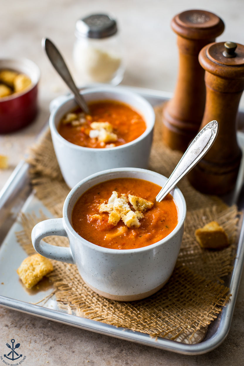 Up close photo of two mugs of tomato roasted red pepper soup