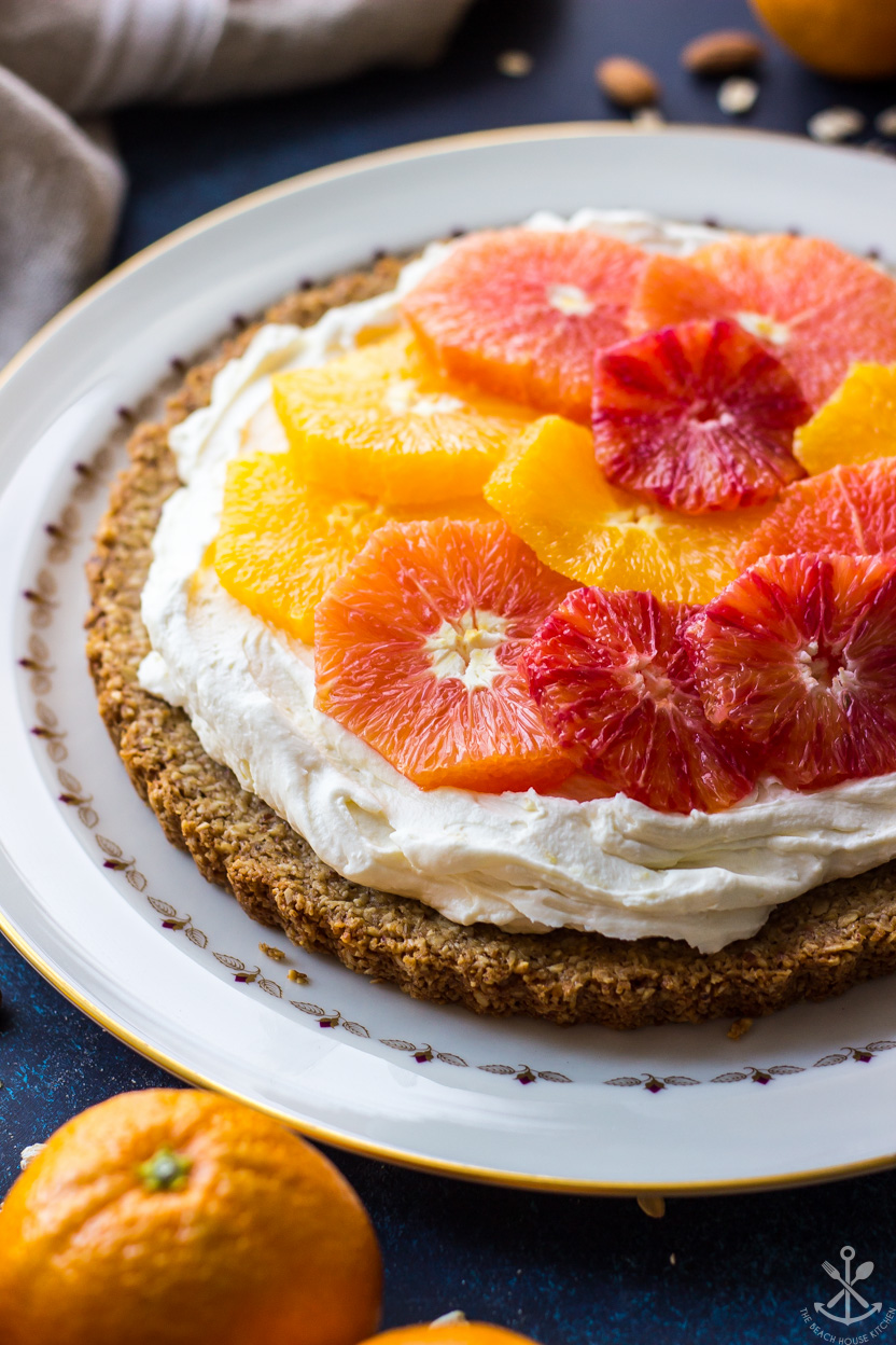 Up close photo of a tart topped with fresh oranges