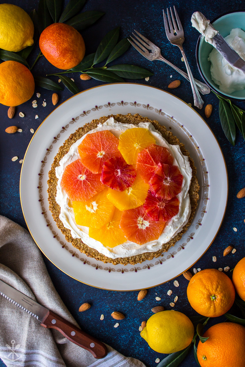 Overhead photo of a tart topped with fresh orange slices