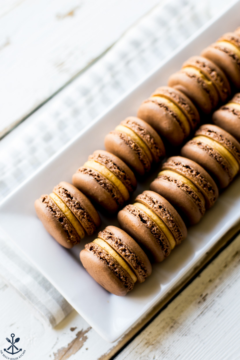 Chocolate Peanut Butter Macarons on a white tray