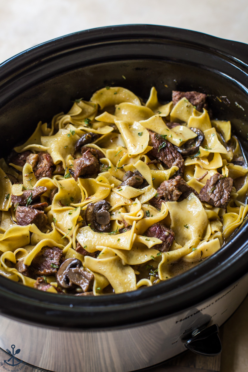 Up close photo of a slow cooker of beef and noodles